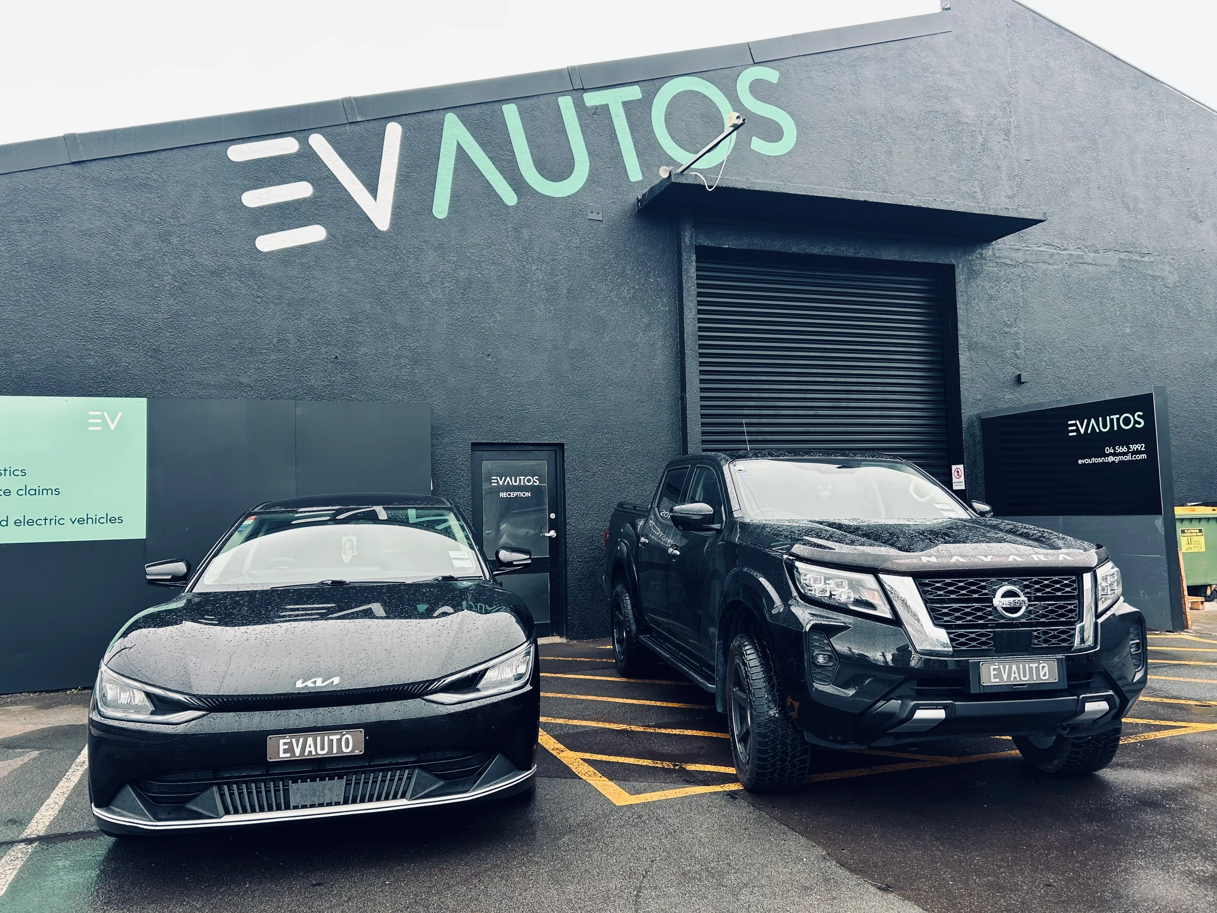 Outside of the garage with two cars parked outside